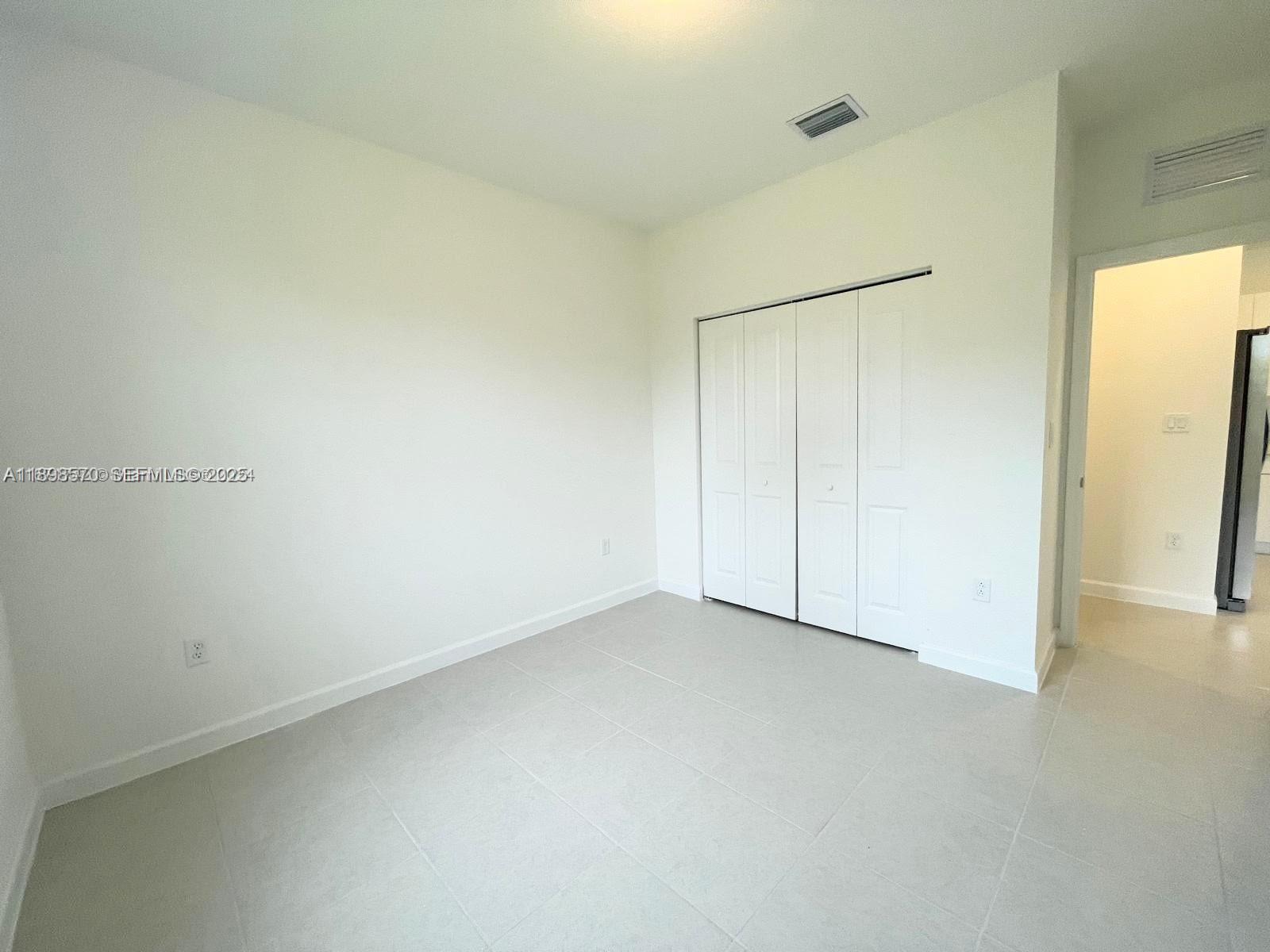 2647 Southeast 8th Street Homestead, FL 33030 - Photo 13 of 25 an empty room with a hallway