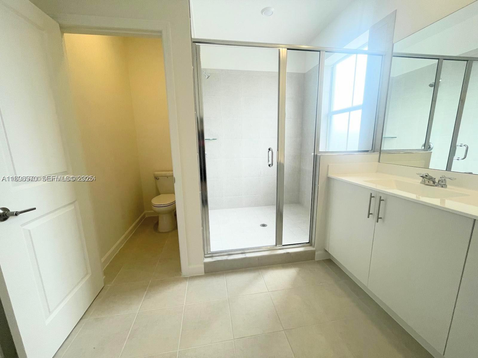 2647 Southeast 8th Street Homestead, FL 33030 - Photo 15 of 25 a bathroom with a sink and a mirror