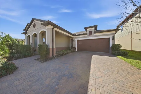 a view of a white house with a yard and garage