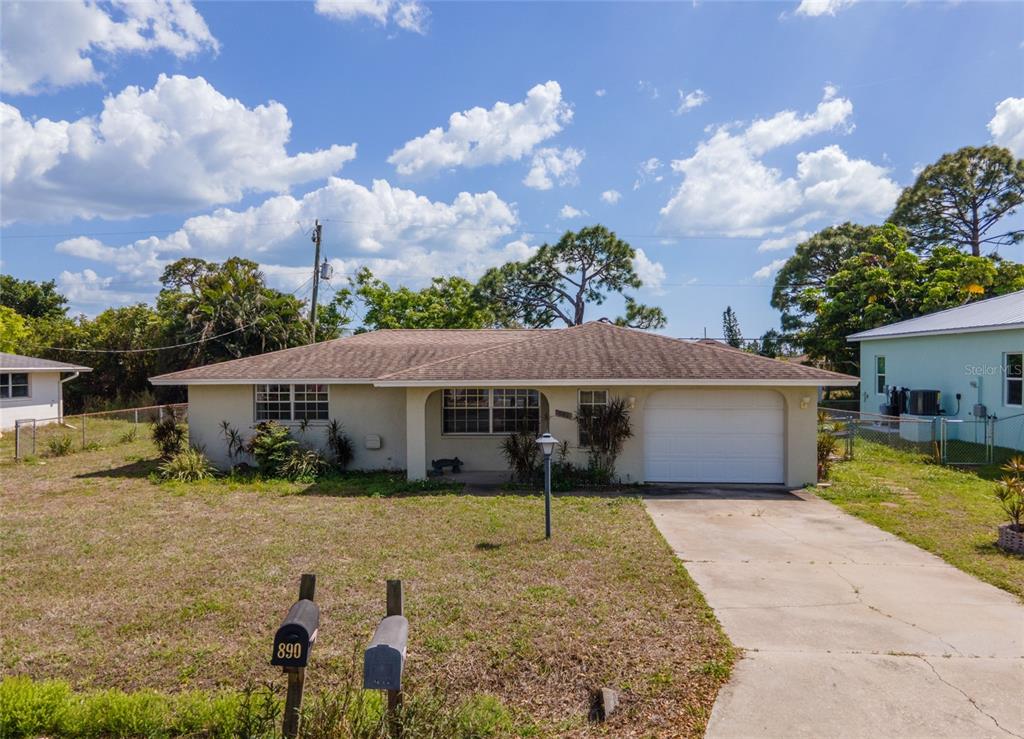 901 Ponderosa Road Venice, FL 34293 - Photo 30 of 33 a front view of a house with a yard and garage