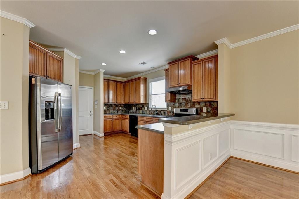 5063 Micaela Way Duluth, GA 30096 - Photo 21 of 61 a kitchen with stainless steel appliances granite countertop a refrigerator a stove and a sink