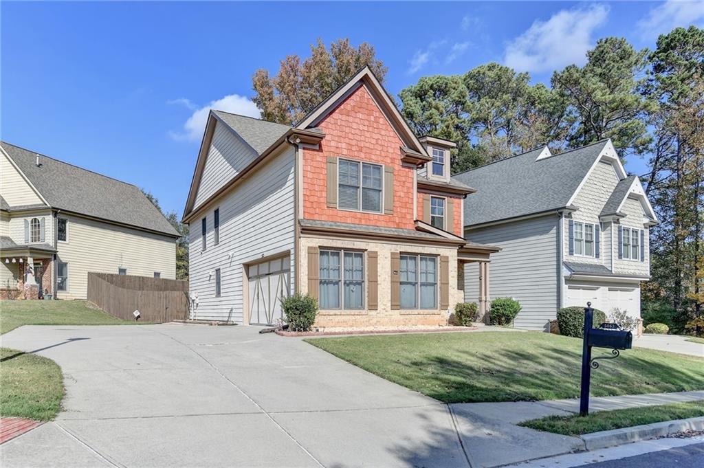 5063 Micaela Way Duluth, GA 30096 - Photo 4 of 61 a front view of a house with a yard and garage