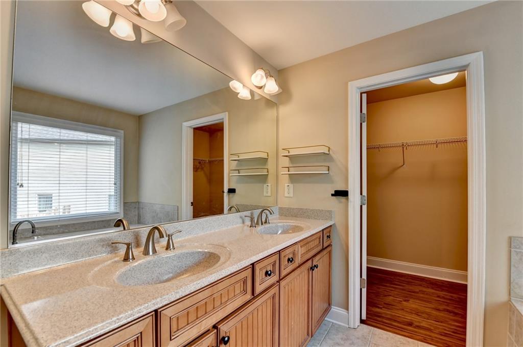 5063 Micaela Way Duluth, GA 30096 - Photo 49 of 61 a bathroom with a sink a vanity and a large mirror