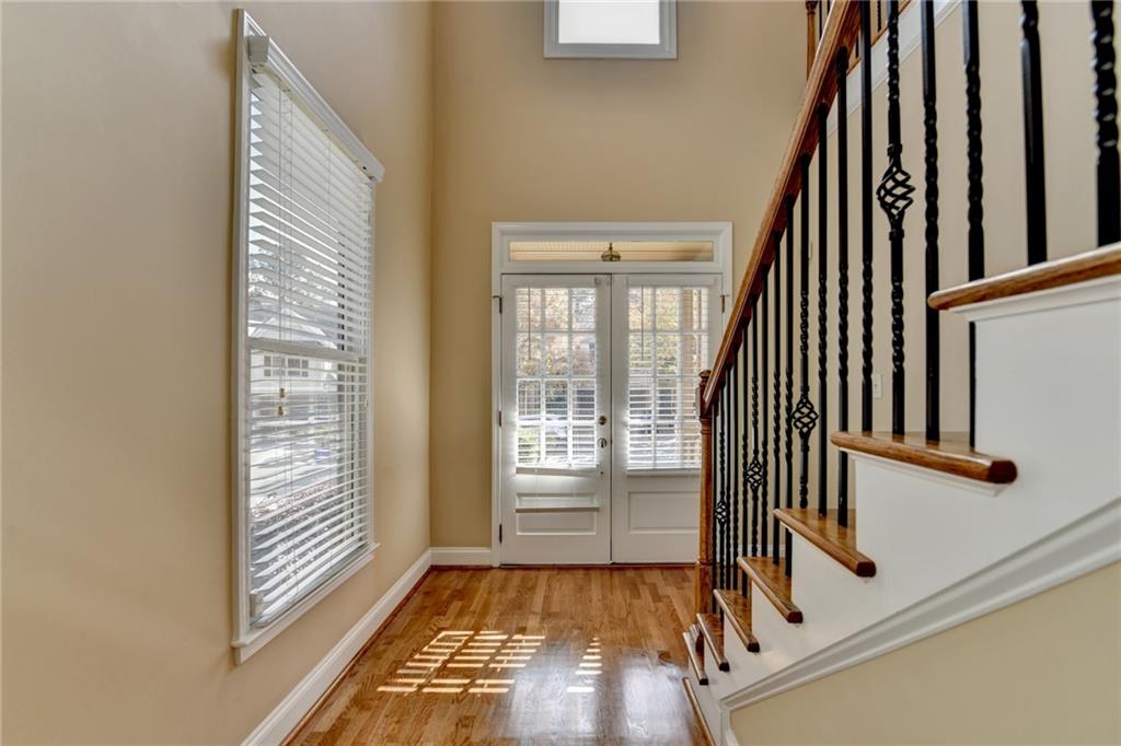 5063 Micaela Way Duluth, GA 30096 - Photo 8 of 61 a view of an entryway with wooden floor and door