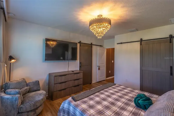 a bedroom with a bed and a television