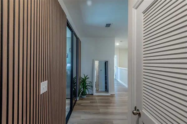 a view of a hallway with wooden floor