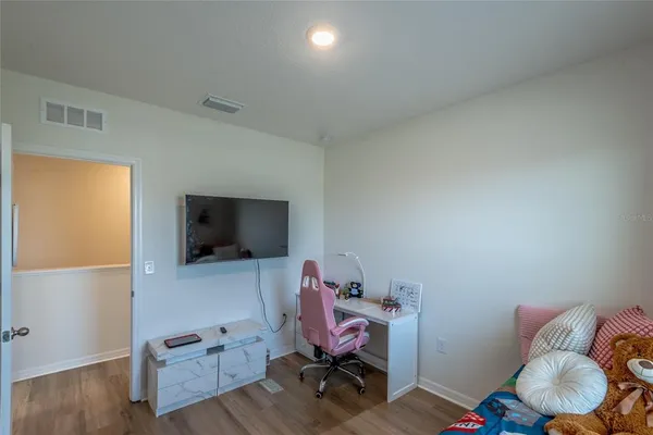 a bed sitting in a bedroom next to a window