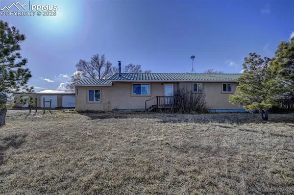 a view of a house with a backyard and garden