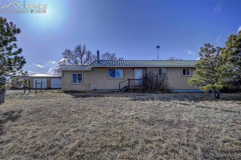 9420 Mulberry Road Calhan, CO 80808 - Photo 1 of 49 a view of a house with a backyard and garden