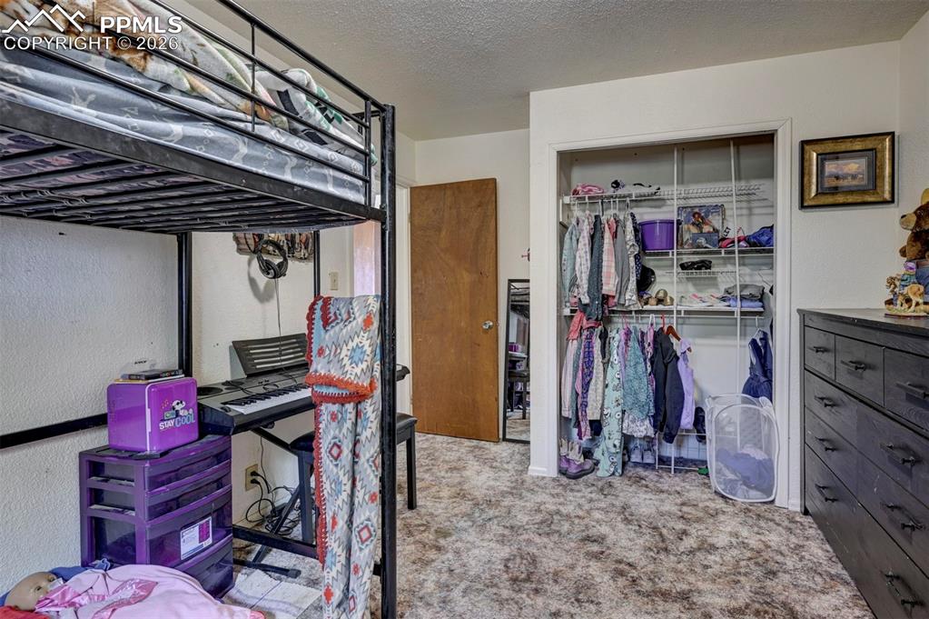 9420 Mulberry Road Calhan, CO 80808 - Photo 23 of 49 a view of walk in closet with clothes and shoes