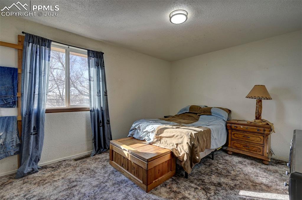 9420 Mulberry Road Calhan, CO 80808 - Photo 25 of 49 a bedroom with a bed and a window