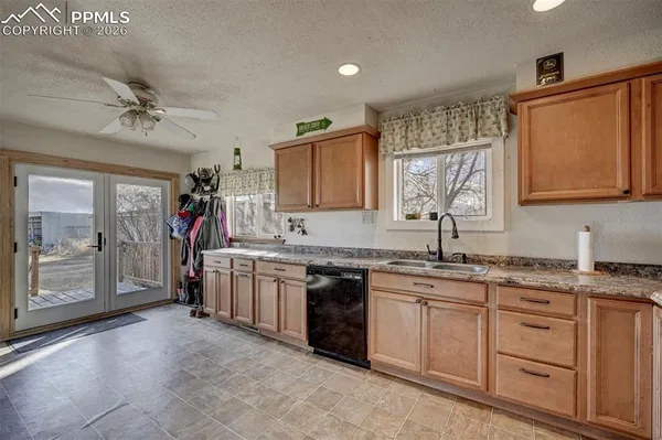 a large kitchen with stainless steel appliances granite countertop a stove sink and cabinets