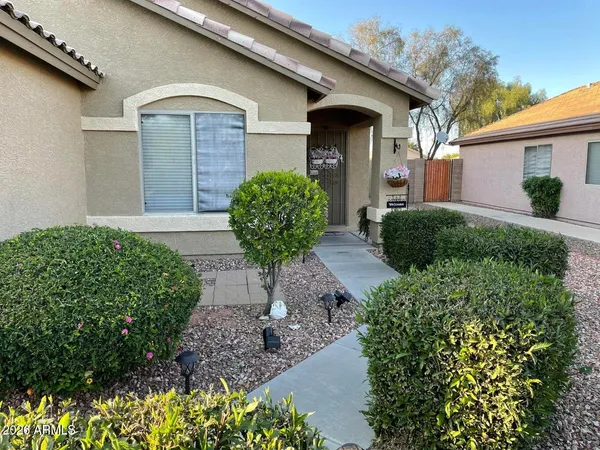 a front view of a house with garden