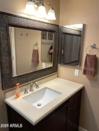 a bathroom with a sink and a mirror