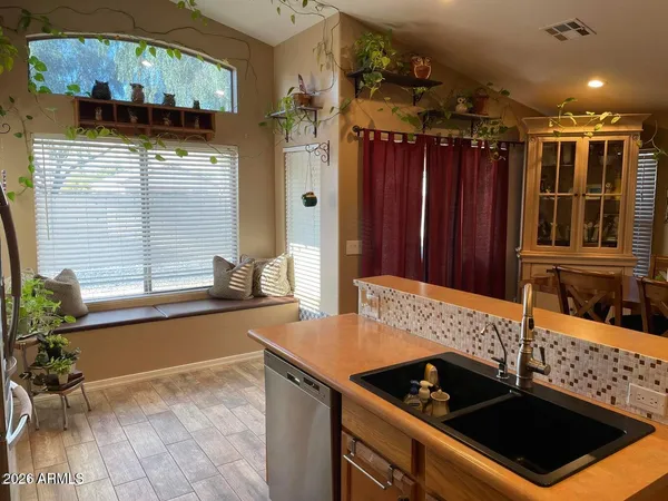 a kitchen with granite countertop a sink stainless steel appliances a counter space and cabinets