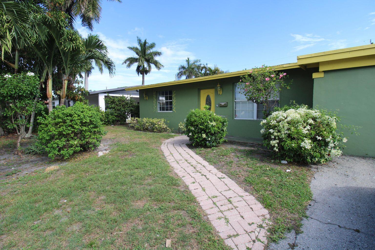 1645 West 31st Street Riviera Beach, FL 33404 - Photo 1 of 20 front view of a house with a yard