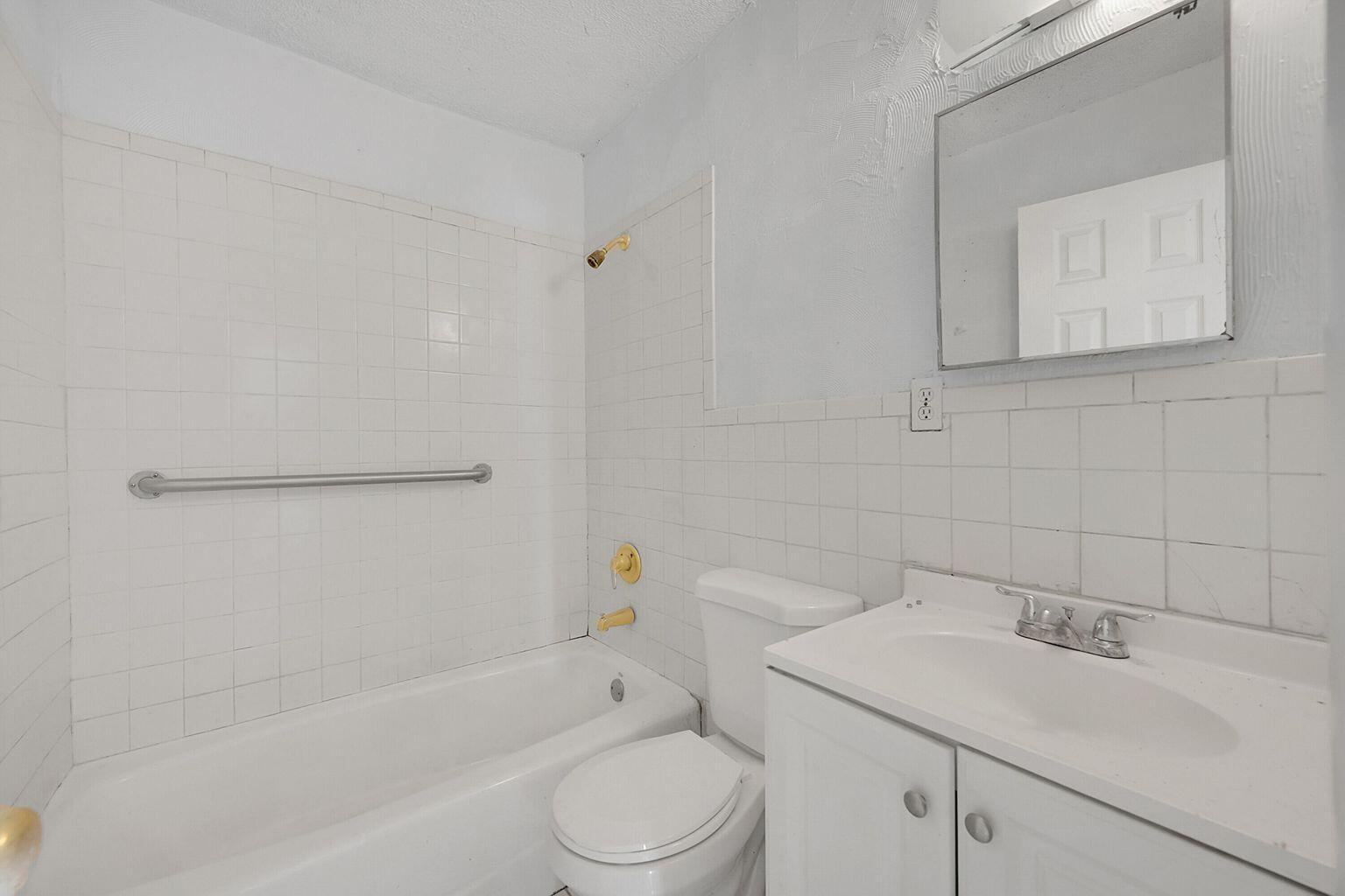 1645 West 31st Street Riviera Beach, FL 33404 - Photo 12 of 20 a bathroom with a sink toilet and vanity