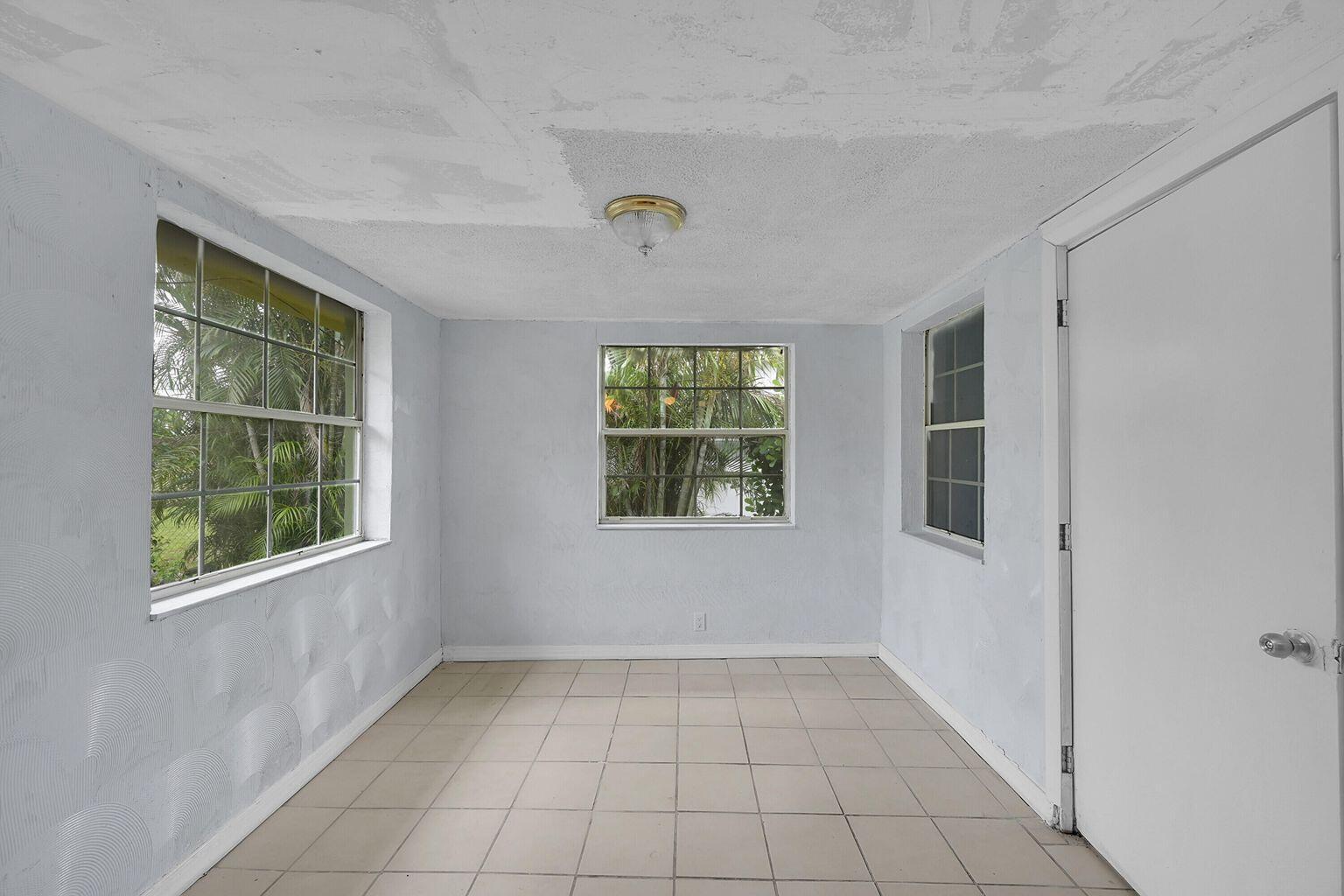 1645 West 31st Street Riviera Beach, FL 33404 - Photo 14 of 20 an empty room with windows