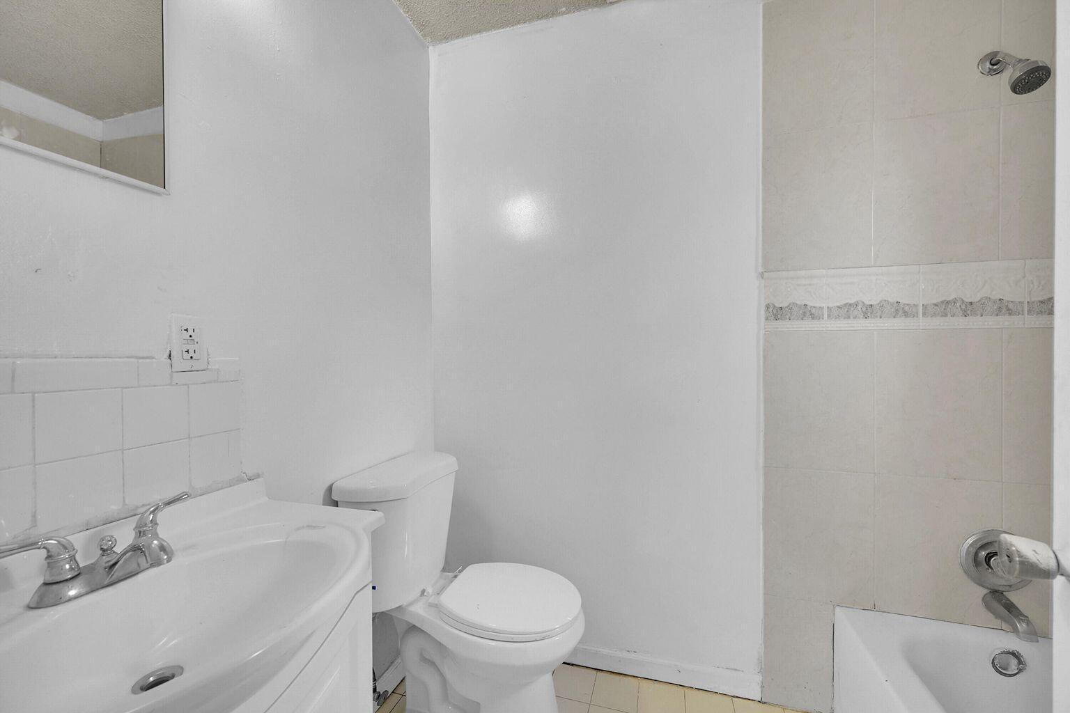 1645 West 31st Street Riviera Beach, FL 33404 - Photo 17 of 20 a bathroom with a sink and a toilet