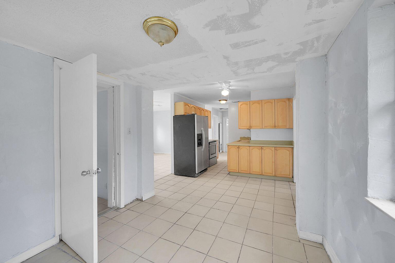 1645 West 31st Street Riviera Beach, FL 33404 - Photo 5 of 20 a view of a refrigerator in kitchen and a window