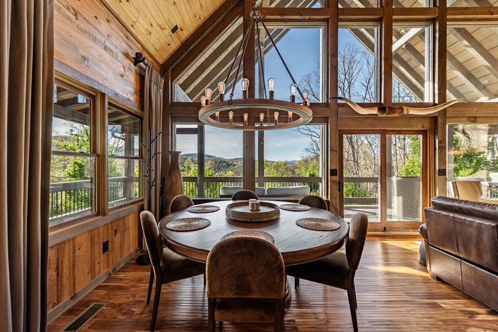 239 Covered Bridge Lane Cherry Log, GA 30522 - Photo 12 of 50 a view of a dining room with furniture large windows and wooden floor