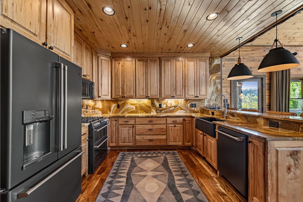 239 Covered Bridge Lane Cherry Log, GA 30522 - Photo 16 of 50 a kitchen with stainless steel appliances granite countertop a sink stove and refrigerator
