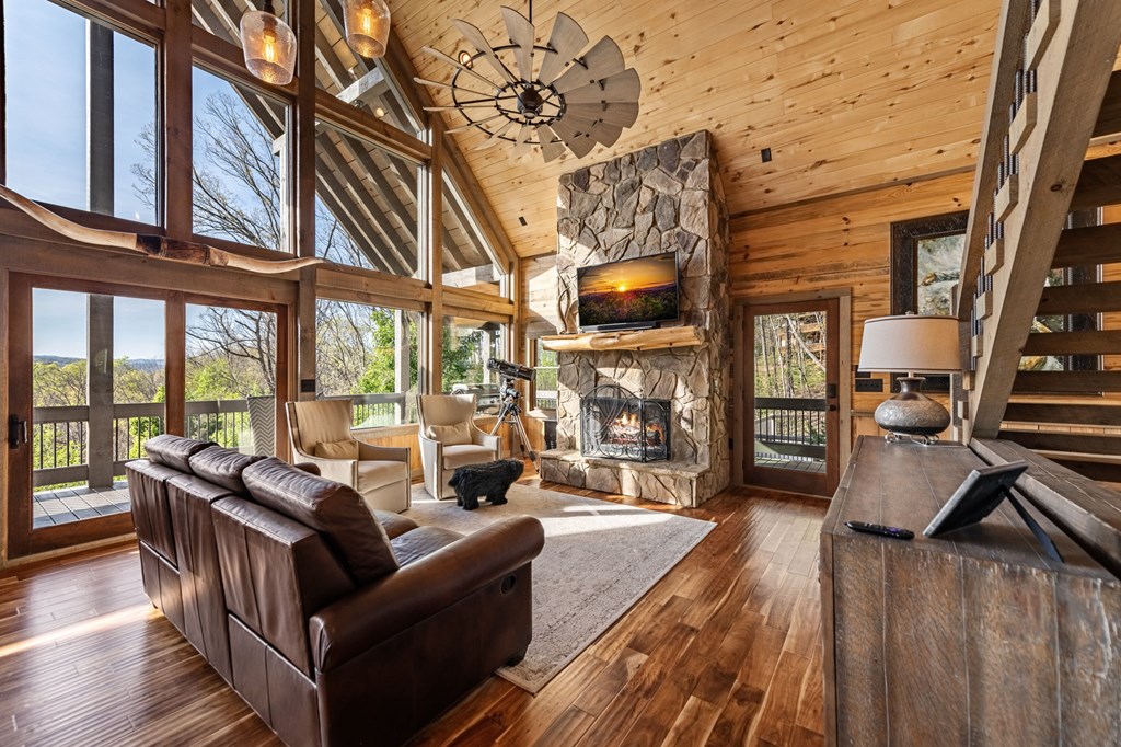 239 Covered Bridge Lane Cherry Log, GA 30522 - Photo 18 of 50 a living room with furniture a flat screen tv and a floor to ceiling window