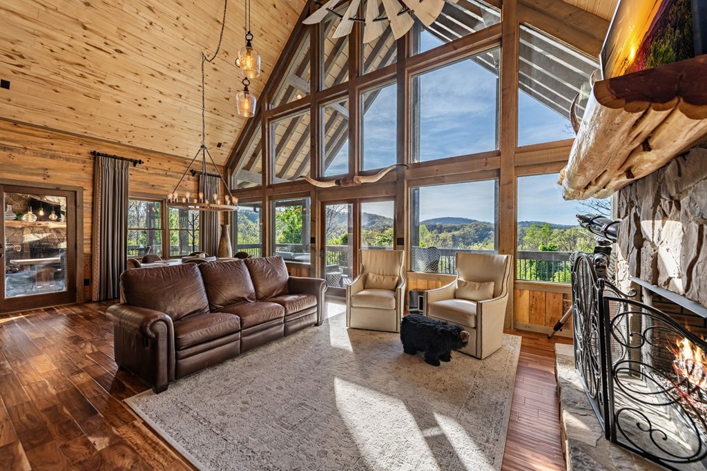 239 Covered Bridge Lane Cherry Log, GA 30522 - Photo 19 of 50 a living room with furniture a floor to ceiling windows and a flat screen tv