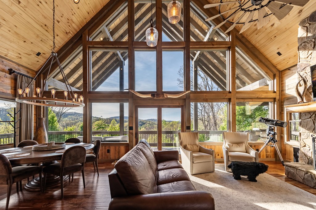 239 Covered Bridge Lane Cherry Log, GA 30522 - Photo 20 of 50 a living room with furniture and floor to ceiling windows