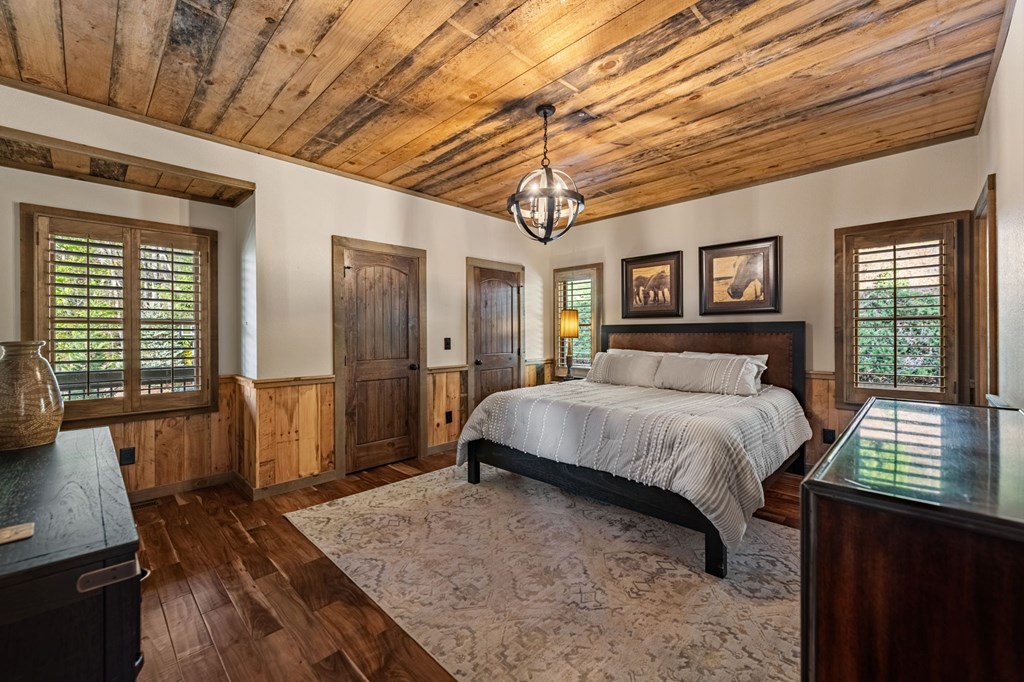 239 Covered Bridge Lane Cherry Log, GA 30522 - Photo 22 of 50 a spacious bedroom with a bed and wooden floor