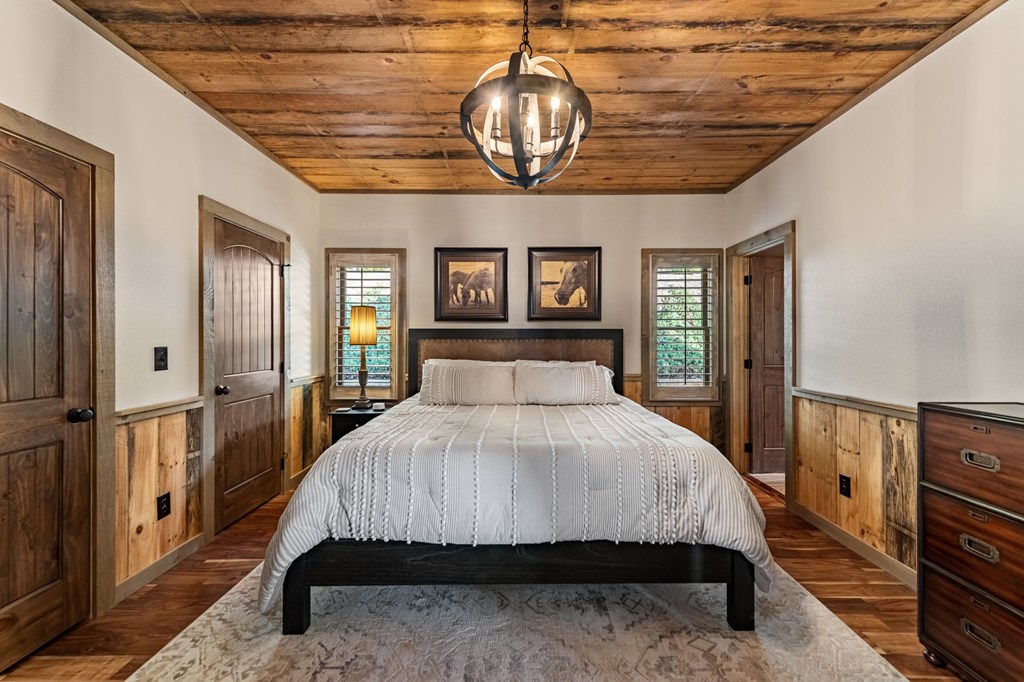 239 Covered Bridge Lane Cherry Log, GA 30522 - Photo 23 of 50 a bedroom with a bed a dresser and flat screen tv