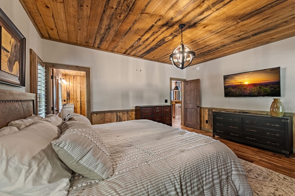 239 Covered Bridge Lane Cherry Log, GA 30522 - Photo 24 of 50 a bedroom with a bed and a flat tv screen on dresser