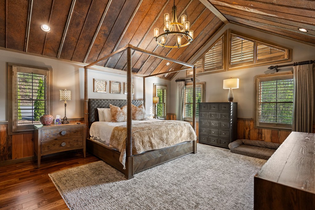 239 Covered Bridge Lane Cherry Log, GA 30522 - Photo 27 of 50 a bedroom with a large bed and a chandelier