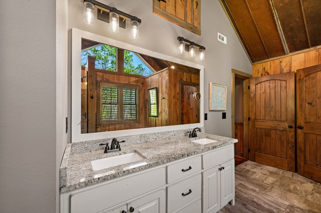 239 Covered Bridge Lane Cherry Log, GA 30522 - Photo 31 of 50 a bathroom with a granite countertop sink and a mirror