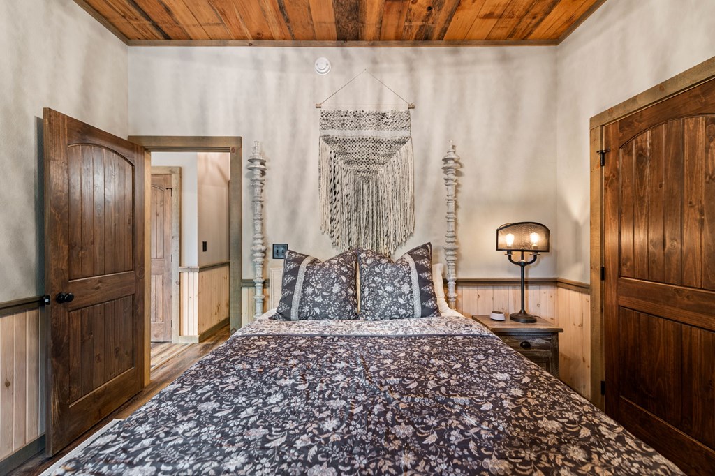 239 Covered Bridge Lane Cherry Log, GA 30522 - Photo 37 of 50 a bedroom with a bed and a chandelier