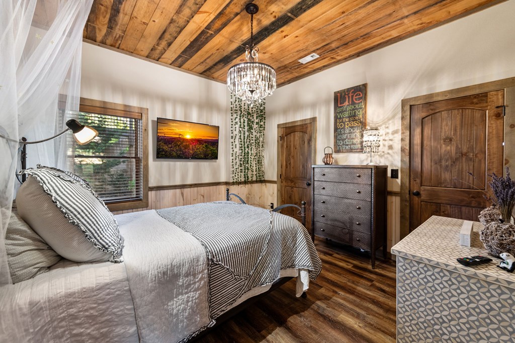 239 Covered Bridge Lane Cherry Log, GA 30522 - Photo 39 of 50 a bedroom with a bed dresser and flat screen tv