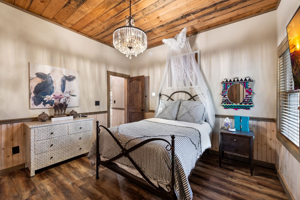 239 Covered Bridge Lane Cherry Log, GA 30522 - Photo 40 of 50 a bedroom with a bed and a chandelier