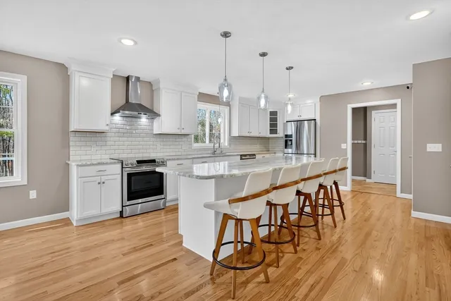 a large kitchen with kitchen island a large island in the center