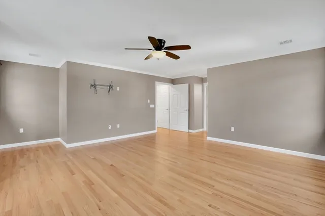 wooden floor in an empty room with a window