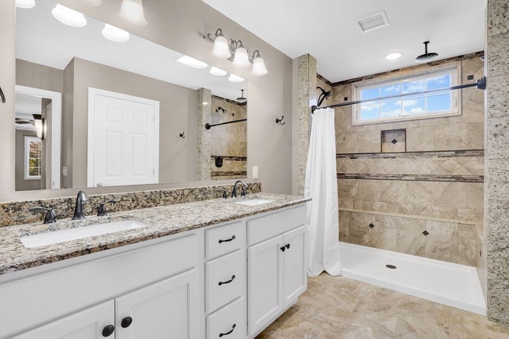 733 Monson Road Wilbraham, MA 01095 - Photo 22 of 40 a bathroom with a granite countertop double vanity sink a mirror and a shower