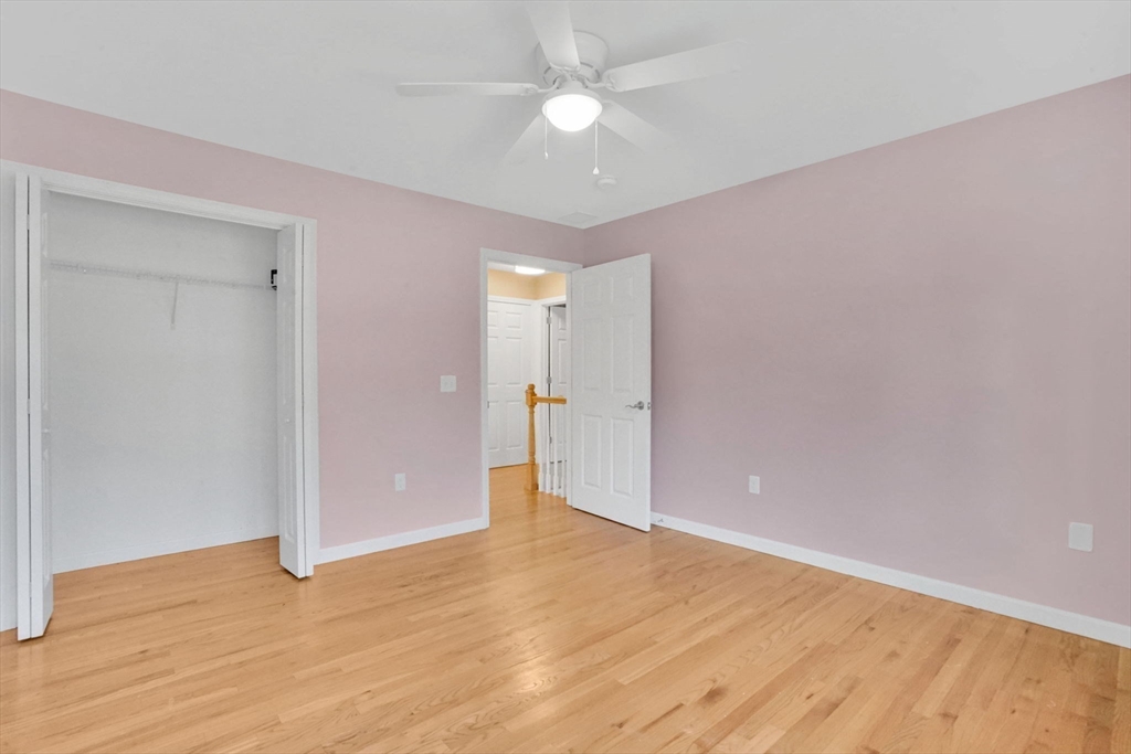 733 Monson Road Wilbraham, MA 01095 - Photo 24 of 40 an empty room with wooden floor and a ceiling fan