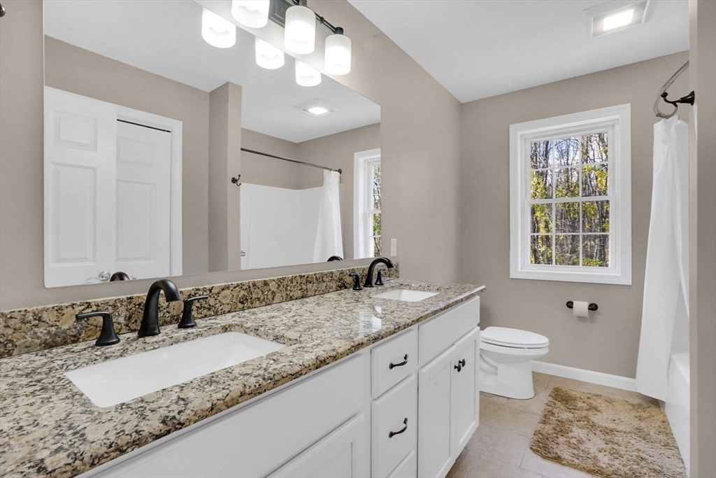 733 Monson Road Wilbraham, MA 01095 - Photo 25 of 40 a bathroom with a granite countertop sink and a mirror