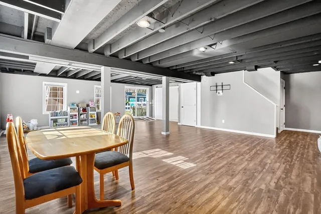 a dining room with furniture a chandelier and wooden floor