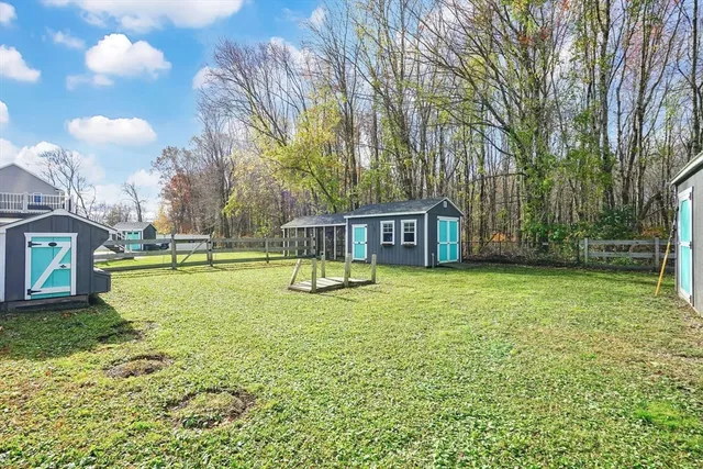 a swimming pool with lots of tress in front of it