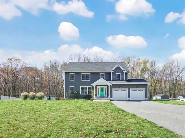 a front view of a house with a yard and garage