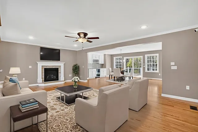 a living room with furniture fireplace and a large window