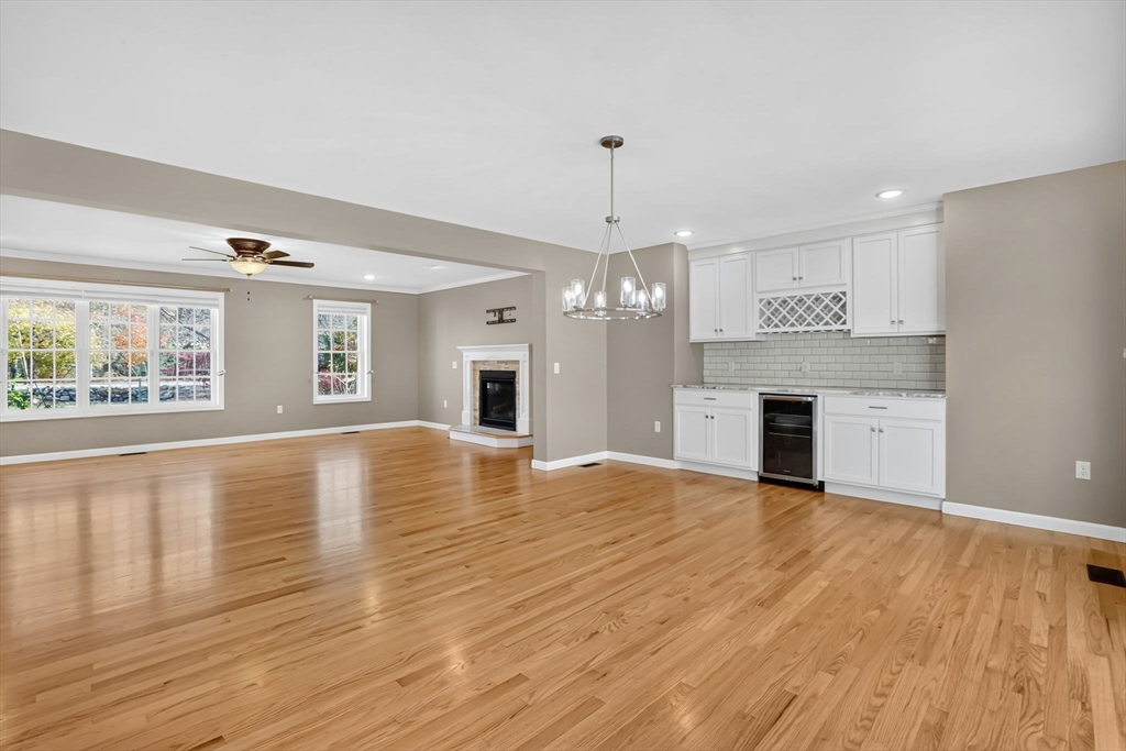 733 Monson Road Wilbraham, MA 01095 - Photo 9 of 40 a view of empty room with wooden floor and kitchen view