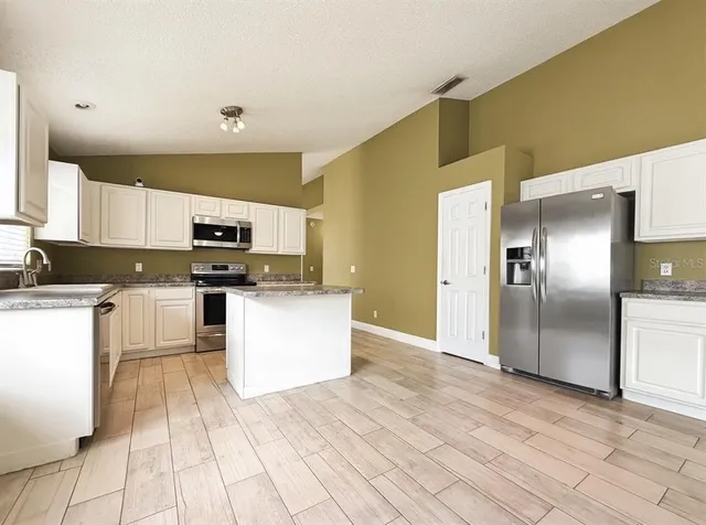 a view of a backyard with a swimming pool