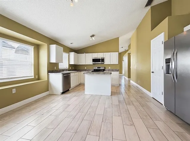a view of a chair and table in backyard of the house