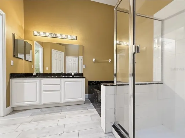 a bathroom with a sink a toilet and a large mirror